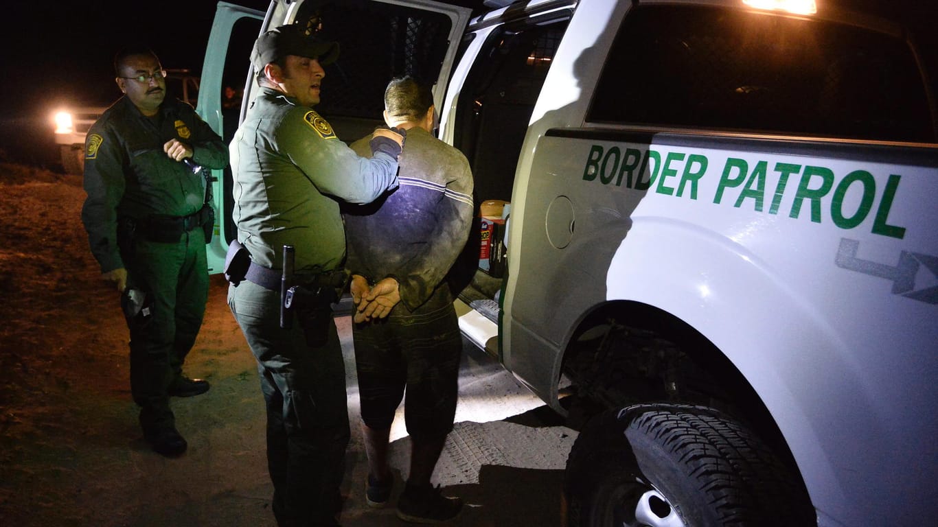 Eine US-Grenzpatrouille durchsucht an der mexikanischen Grenze eine Person, die verdächtigt wird, illegal einreisen zu wollen.