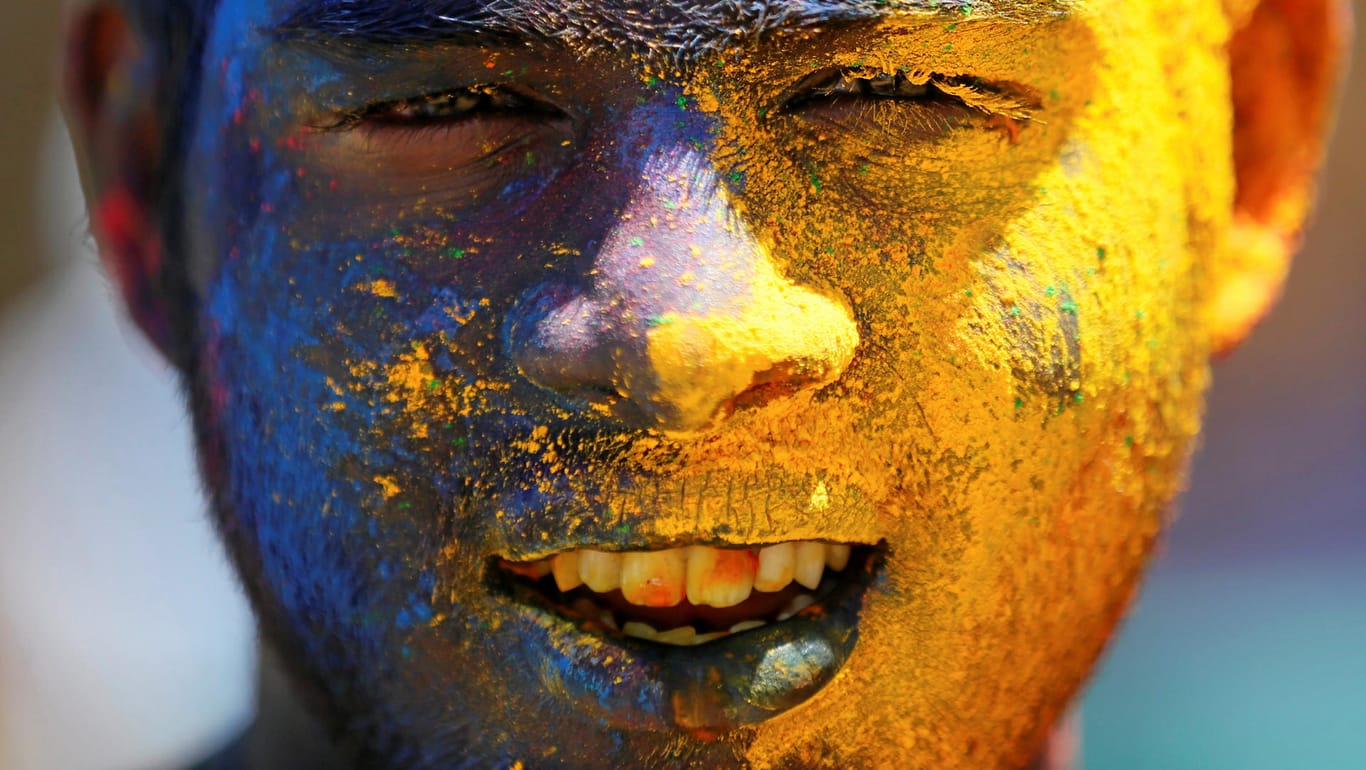A boy with his face smeared in coloured powder, is seen during Holi, the Festival of Colours organised by " Colombo Indians", Indians who live in Colombo