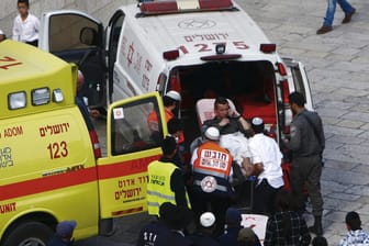 Ein verletzter Grenzpolizist wird in einen Krankenwagen geschoben.