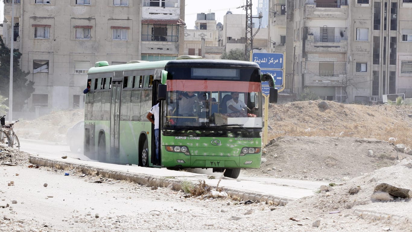 Symbolbild: Ein Bus mit Flüchtlingen verlässt das syrische Dorf al-Waer in der Nähe von Homs.