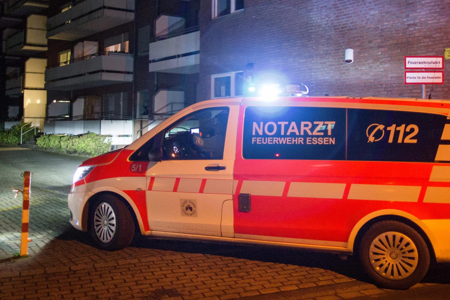 Ein Notarzt-Fahrzeug steht in Essen vor dem Mehrfamilienhaus, in dem ein Ruhestörer erschossen wurde.