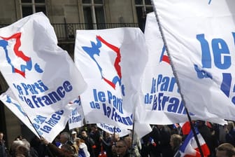 Teilnehmer einer rechten Kundgebung zum Tag der Arbeit schwenken in Paris Flaggen mit der Aufschrift "The French party".