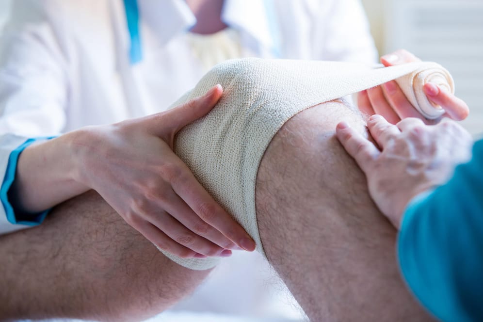 Ein Knie wird verbunden.