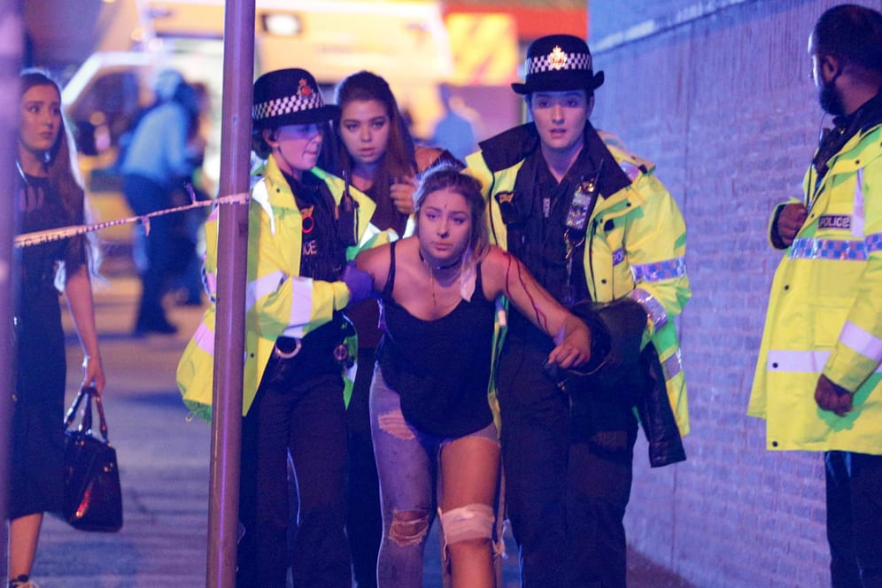 Polizisten helfen in Manchester einer Verletzten.
