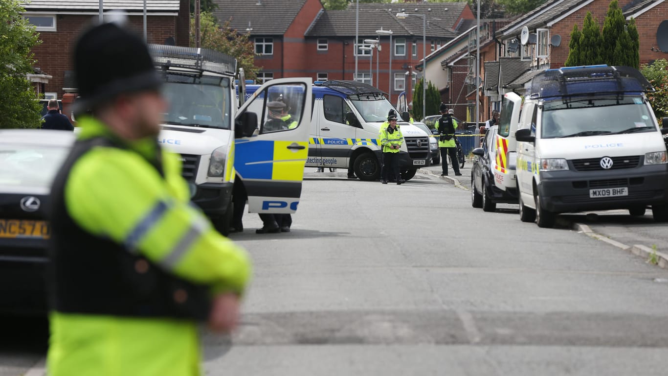 Polizisten sperren in Manchester während eines Einsatzes eine Straße ab.