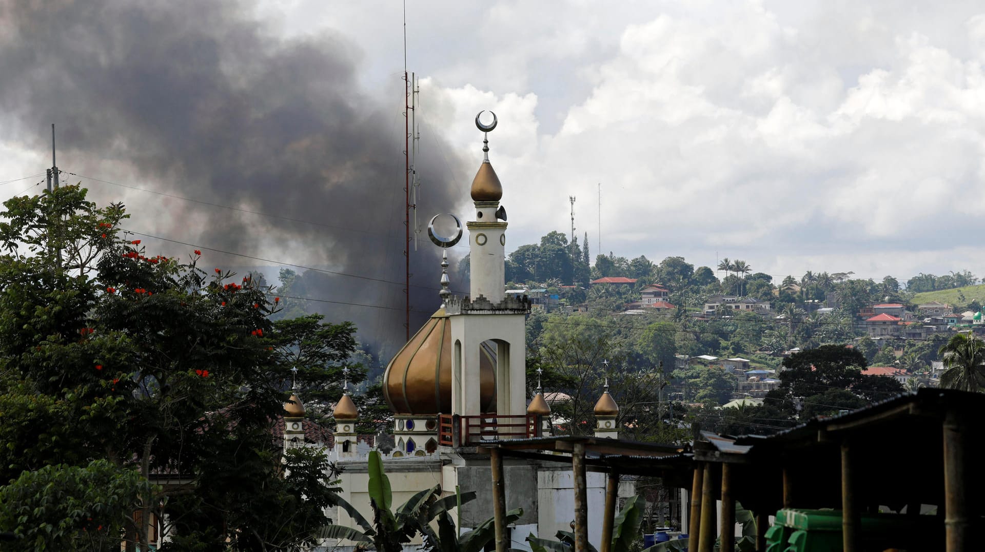 Eine Rauchwolke an der Stelle eines Kampfes neben einer Moschee in Marawi. Eine Rauchwolke an der Stelle eines Kampfes neben einer Moschee in Marawi.