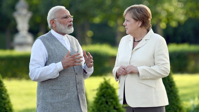 Angela Merkel diskutiert mit dem indischen Premierminister Narendra Modi im Garten des Gästehauses der Bundesregierung in Meseberg.