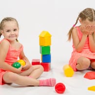 Zwei Mädchen: Beim gemeinsamen Spielen kommt es zwischen Kindern manchmal zu Streit – zum Beispiel, wenn sie ihre Spielsachen nicht teilen wollen.
