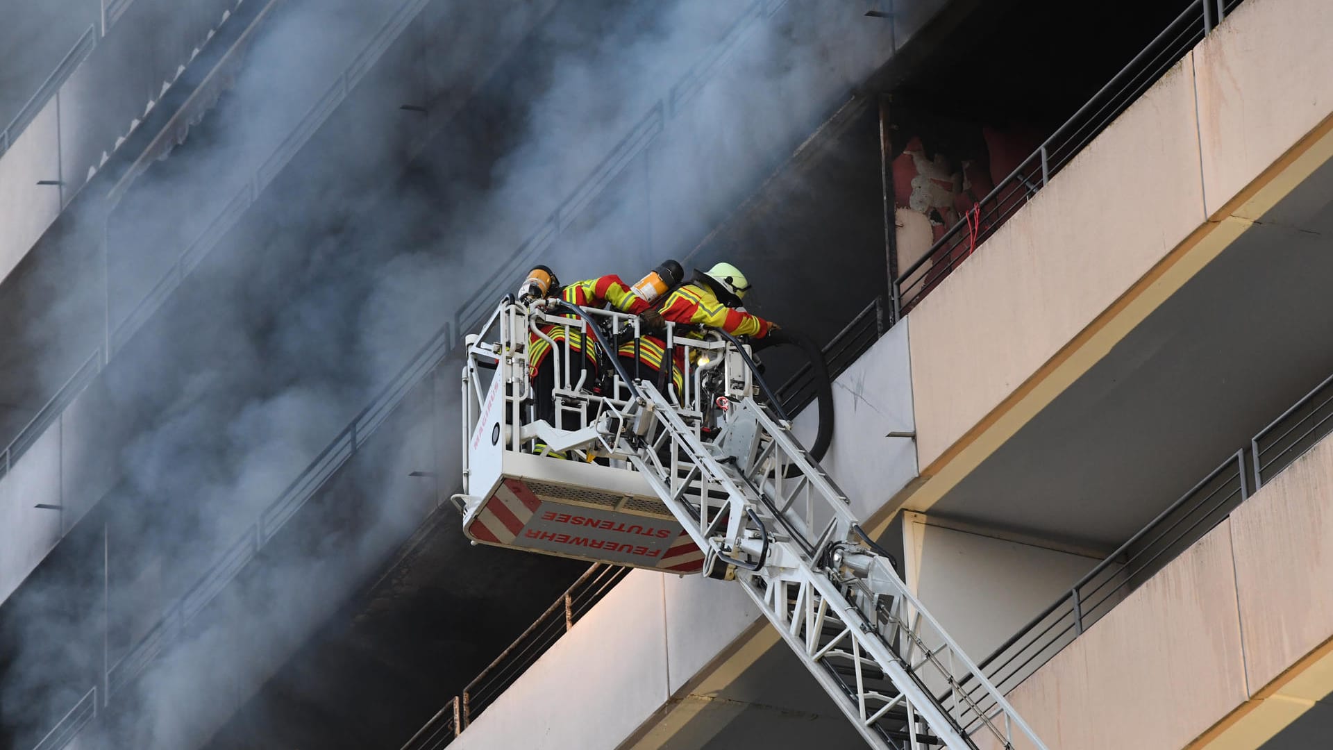 Feuerwehrleute löschen den Brand in einem Hochhaus in Stutensee bei Karlsruhe. Feuerwehrleute löschen den Brand in einem Hochhaus in Stutensee bei Karlsruhe.