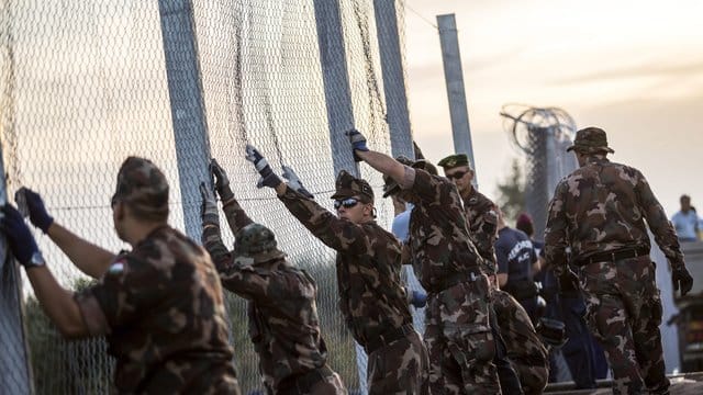 Ungarische Soldaten errichten im September 2015 an der Grenze zu Serbien einen Grenzzaun. Ungarische Soldaten errichten im September 2015 an der Grenze zu Serbien einen Grenzzaun.