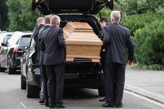Mitarbeiter eines Beerdigungsinstituts transportieren einen Sarg aus dem Haus von Helmut Kohl.