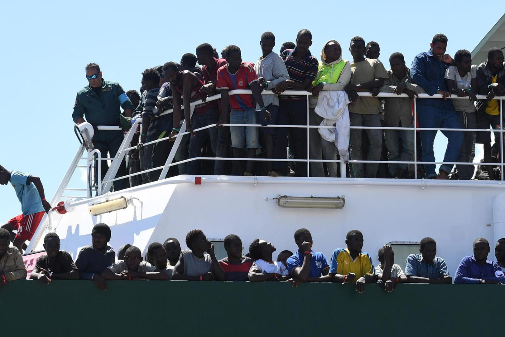 Migranten stehen am Deck des spanischen Schiffes «Rio Segura». Über 1200 Migranten, darunter Kinder, wurden aus dem Mittelmeer gerettet. Italien hatte gedroht, Schiffe mit geretteten Migranten vor den Häfen abzuweisen, wenn es nicht mehr Unterstützung durch die EU gebe.