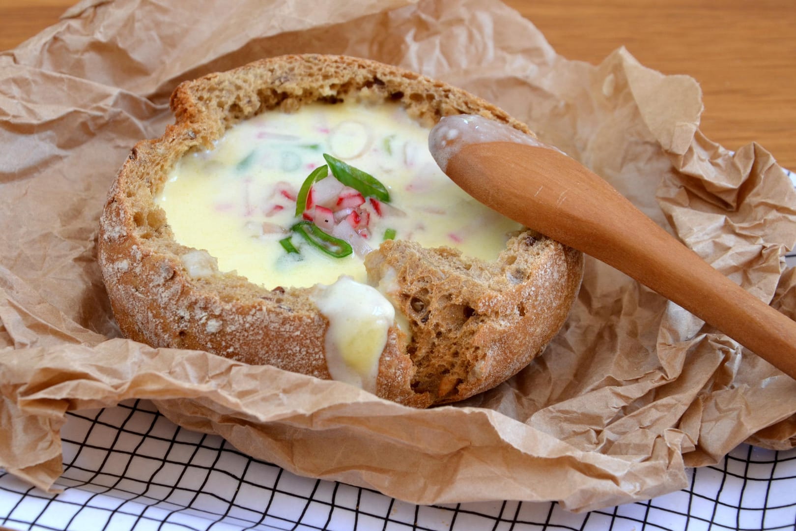 Herzhafter Käse verwandelt das Brötchen in einen besonderen Snack. Radieschen und Lauchzwiebeln sind ein leckeres Topping.