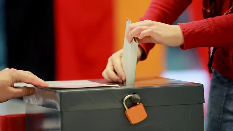 Eine Wählerin wirft ihren Wahlzettel zur Bundestagswahl in die Urne.