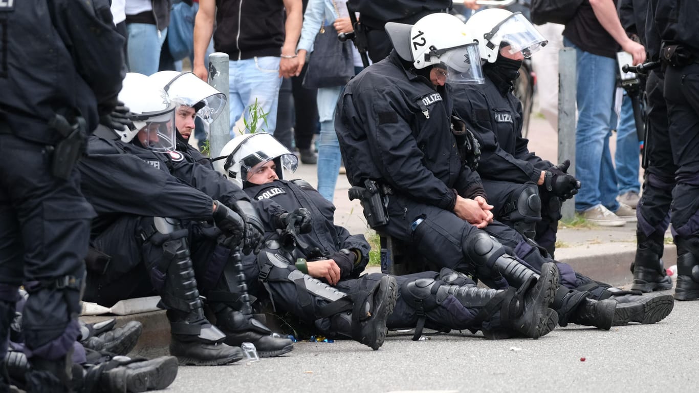Polizisten ruhen sich am Rande der Demonstration "Grenzenlose Solidarität statt G20" aus.