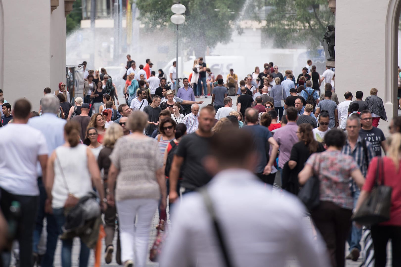 Passanten gehen in München durch die Fußgängerzone.