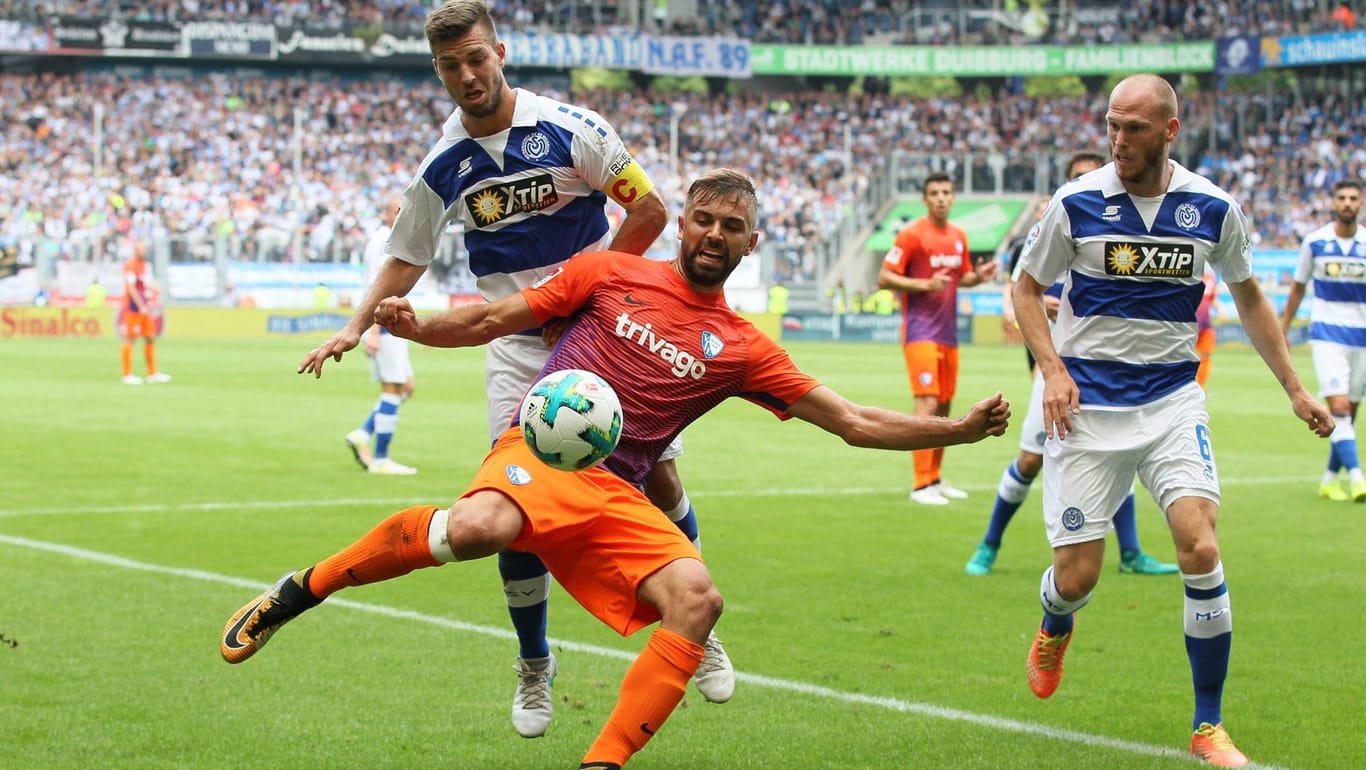 Bochums Lukas Hinterseer schirmt den Ball gegen Duisburg-Kapitän Kevin Wolze ab.
