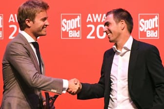 Weltmeister unter sich: Formel-1-Weltmeister Nico Rosberg (l) ehrt Fußball-Weltmeister Philipp Lahm.