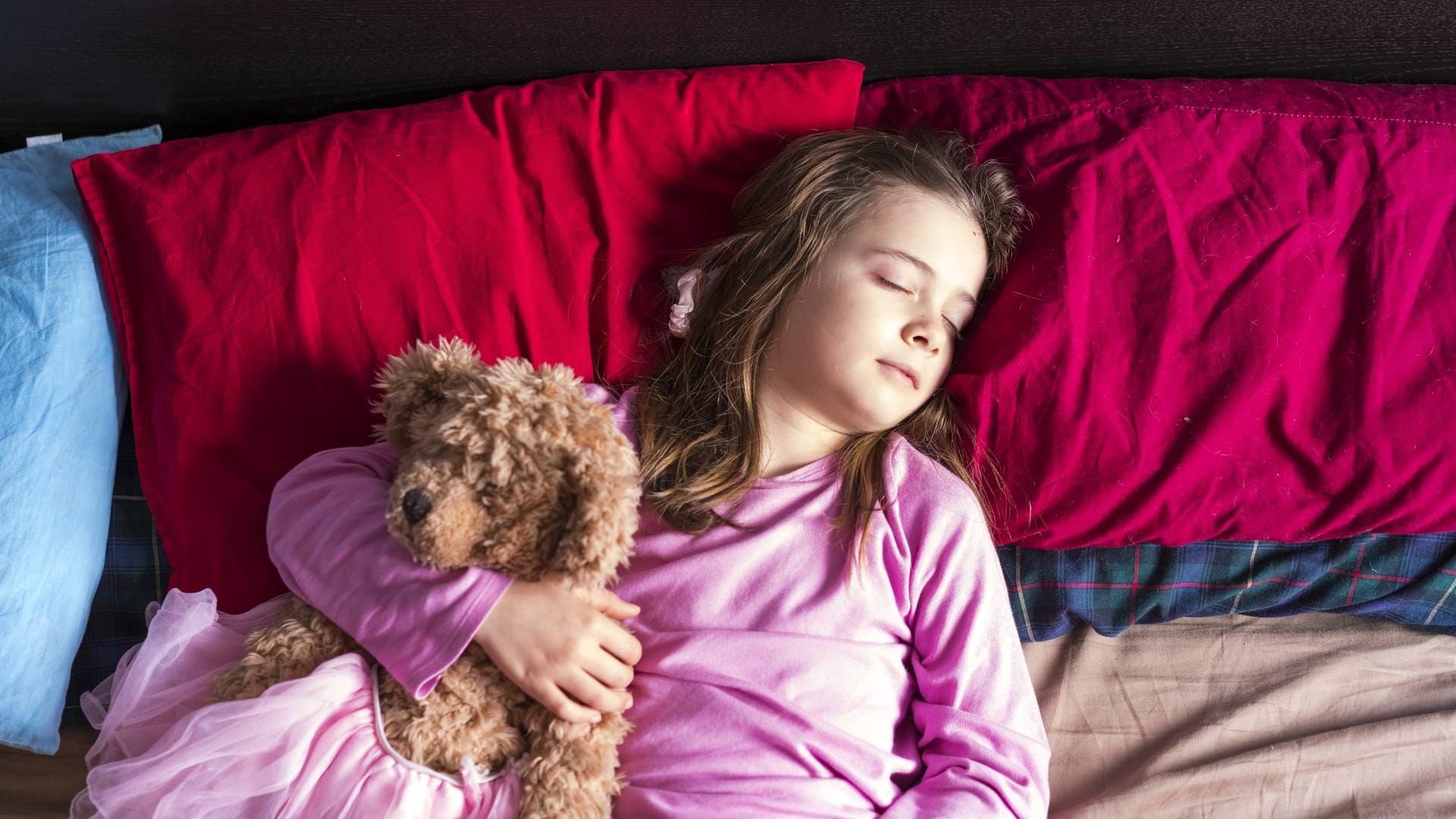 Ein schlafendes Mädchen mit Teddy