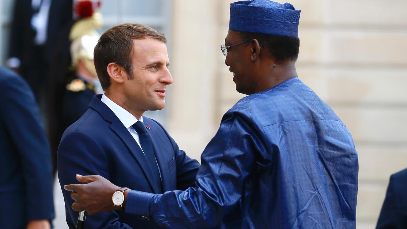 Emmanuel Macron und der Präsident des Tschad, Idriss Deby, begrüßen sich.