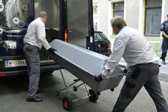 Die Leiche des getöteten Mädchens wird in einem Sarg aus einer Wohnhausanlage in Wien gebracht und in einen Leichenwagen gehoben.