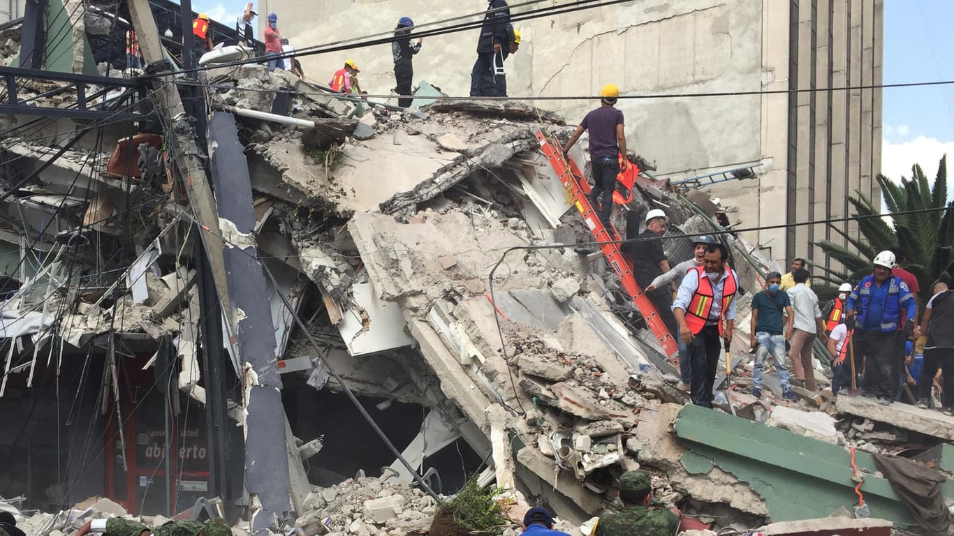 Rettungskräfte und Freiwillige suchen in den Trümmern eines eingestürzten Hauses in Mexiko-Stadt nach Überlebenden.