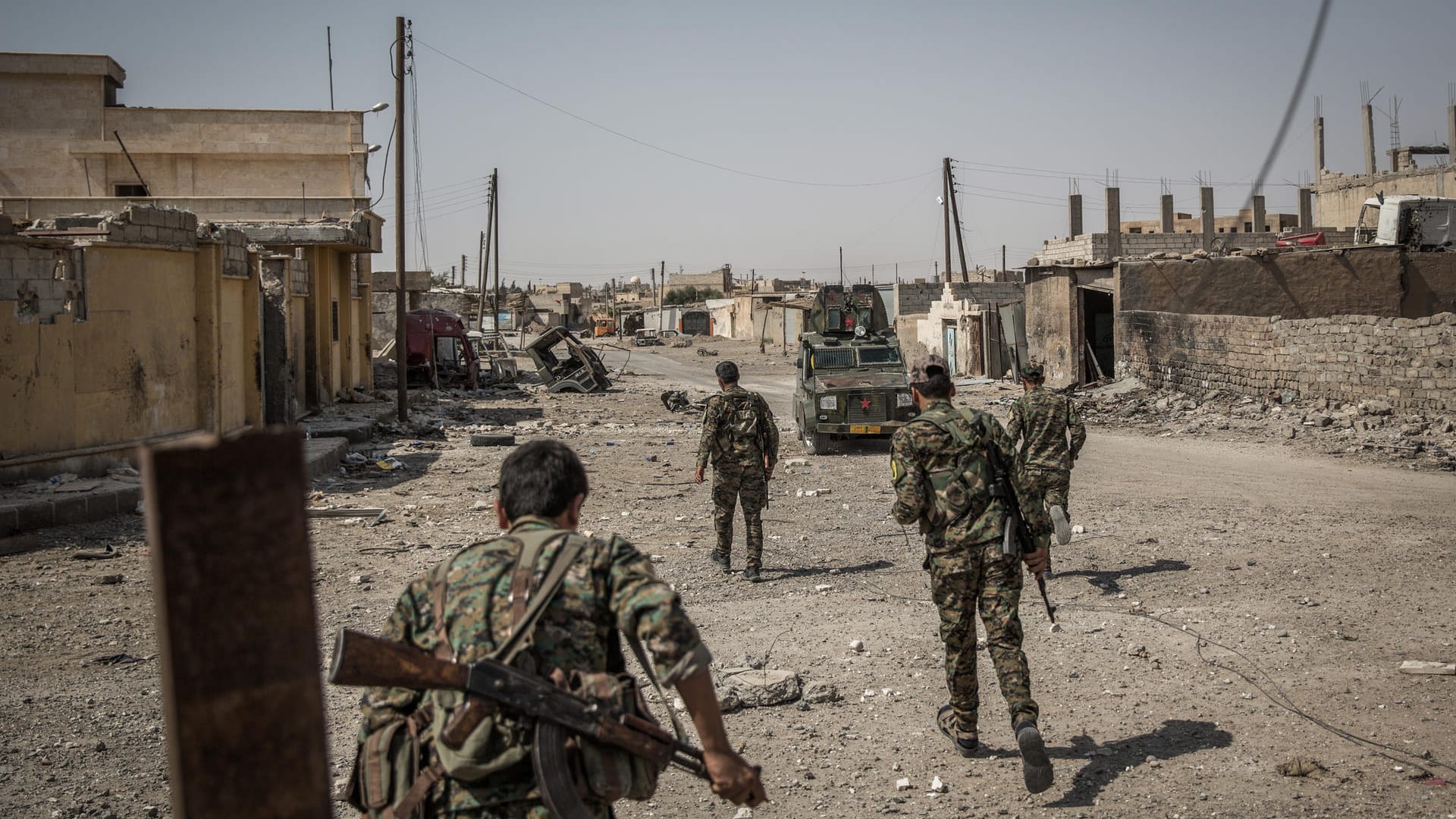 Soldaten der Syrischen Demokratischen Kräfte überqueren eine Straße in Al-Rakka (Syrien). Soldaten der Syrischen Demokratischen Kräfte überqueren eine Straße in Al-Rakka (Syrien).