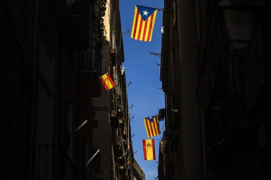 "Estelada"-Flaggen der Unabhängigkeitsbewegung Kataloniens sowie spanische Nationalflaggen hängen in Barcelona an Balkonen.