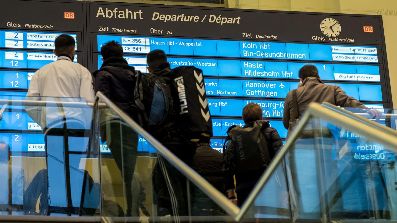 Zugreisende stehen warten in Hannover auf eine Verbindung.