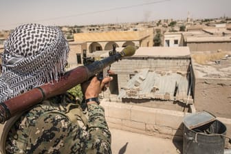 Ein Kämpfer der syrisch-kurdischen YPG-Miliz vor der Stadt Rakka im Juli: USA und Bundeswehr haben die Truppe mit Waffen beliefert.
