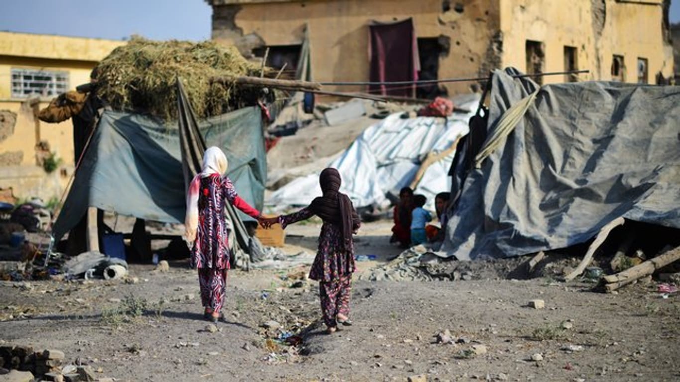 Zwei Mädchen laufen durch ein Flüchtlingslager für Binnenvertriebene in Kabul.