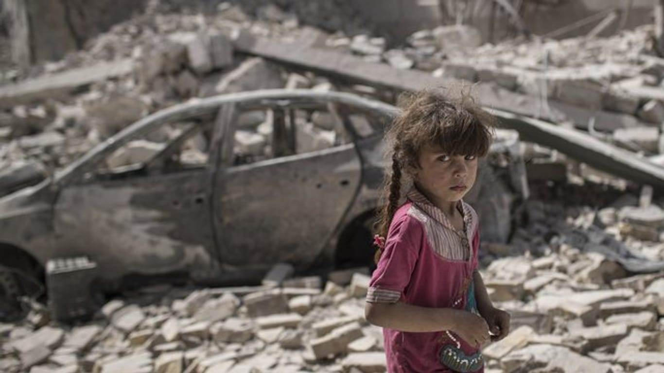 Ein Mädchen flieht durch eine zerstörte Gasse der irakischen Stadt Mossul.