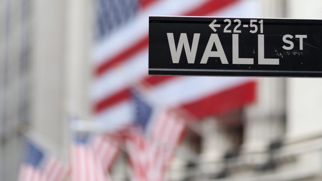 Blick auf die Börse in New York hinter einem Wall Street-Schild: Der Dow Jones ist dank weltweit guter Konjukturdaten im Aufwind.
