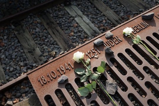 Blumen liegen im Gedenken an den Beginn der Deportationen von Juden aus Berlin am Gleis 17 im Bahnhof Grunewald.