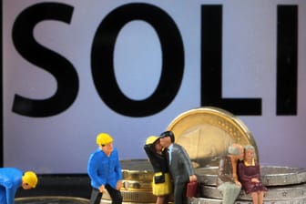 Modellfiguren mit Euro-Münzen: Union und SPD haben sich auf die schrittweise Abschaffung des Solidaritätszuschlags geeinigt.