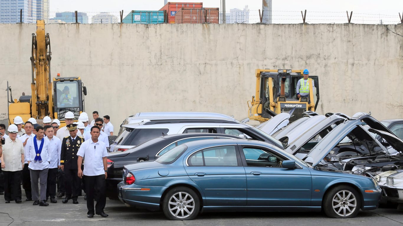 President Rodrigo Duterte inspects condemned for destruction smuggled luxury cars worth 61,626,000.00 pesos (approximately US$1.2 million), during the 116th Bureau of Customs founding anniversary in Metro Manila