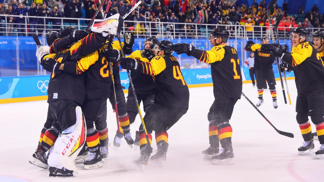 Das deutsche Eishockeyteam bejubelt den Viertelfinalsieg gegen Schweden.