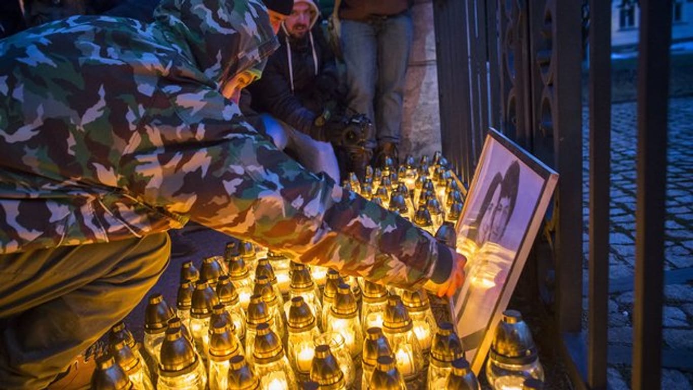 Trauernde zünden bei einem stillen Protestmarsch Kerzen an.
