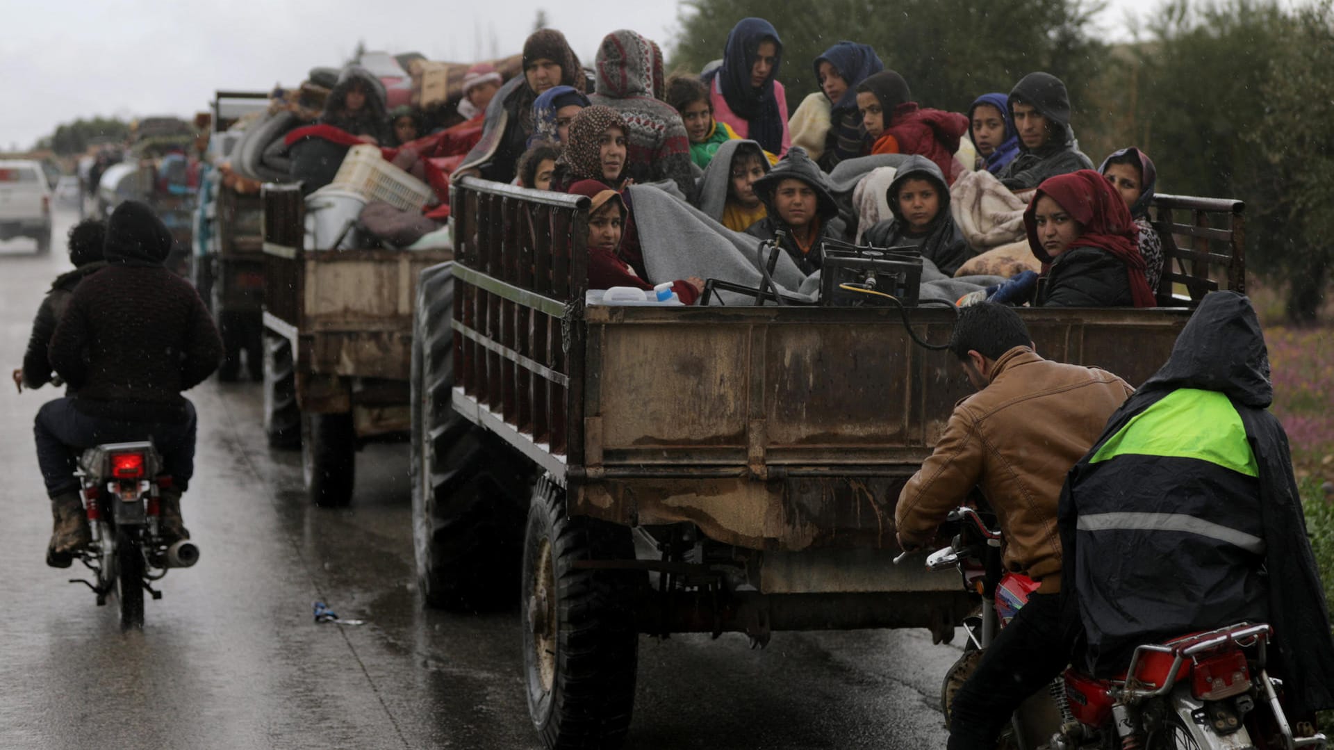 Fliehende Menschen sitzen zusammengedrängt auf einem Lastwagen, der sie aus Afrin bringt.