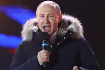 Russian President and Presidential candidate Putin delivers a speech during a rally and concert marking the fourth anniversary of Russia's annexation of the Crimea region, in central Moscow