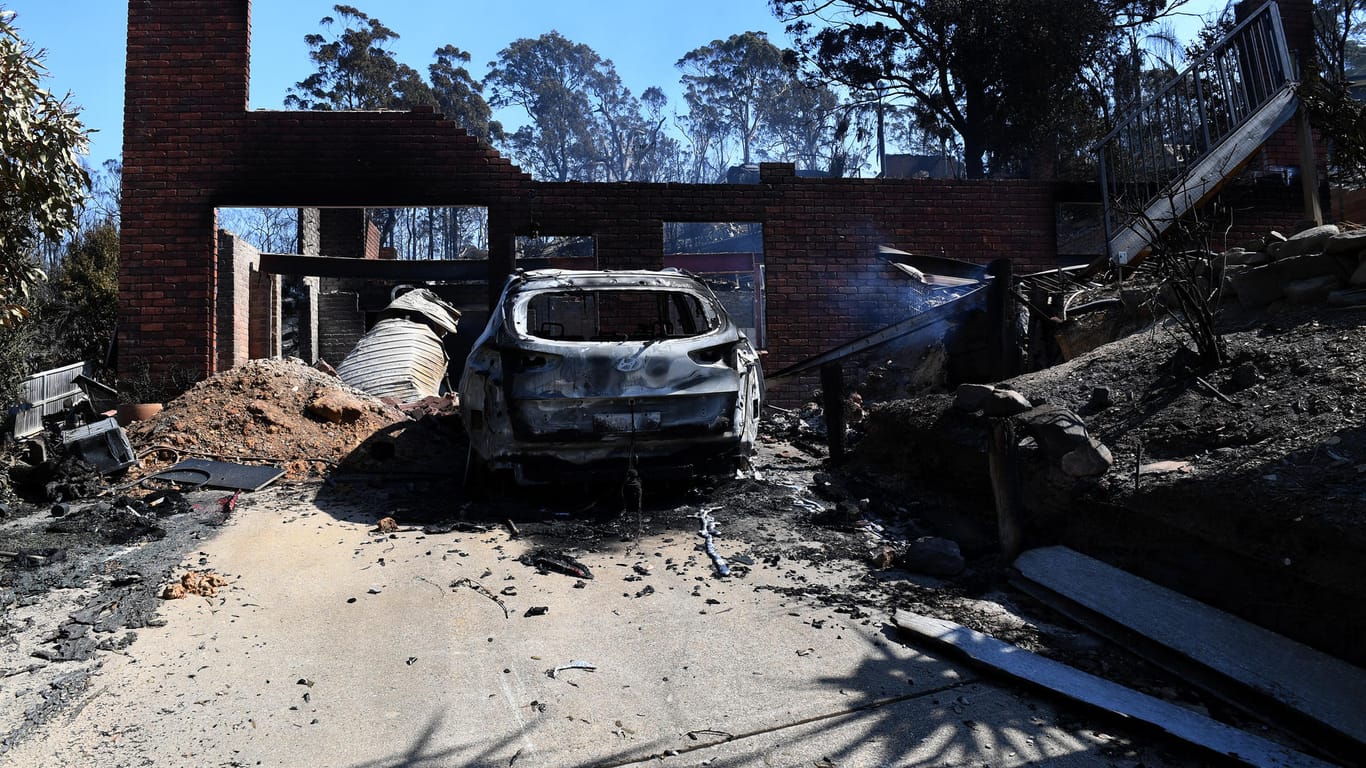 Ein verbranntes Auto vor einem zerstörten Haus im australischen Tathra: Nach einem Buschfeuer standen über 70 Häuser in Flammen.