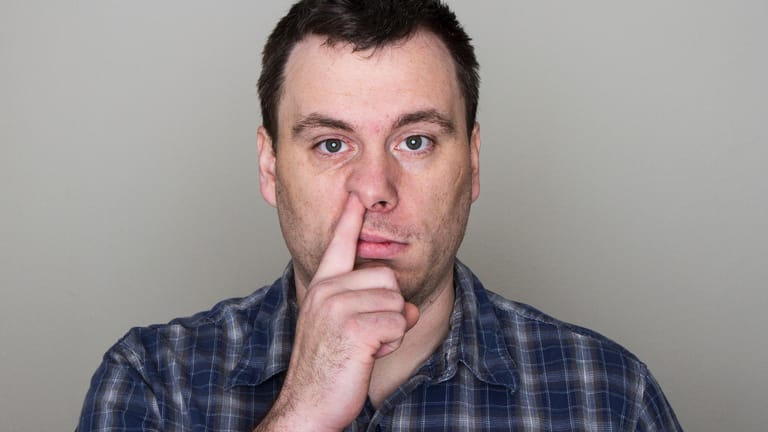 Mann bohrt in der Nase: Eine gesunde Nase steckt nicht ständig voller Popel.