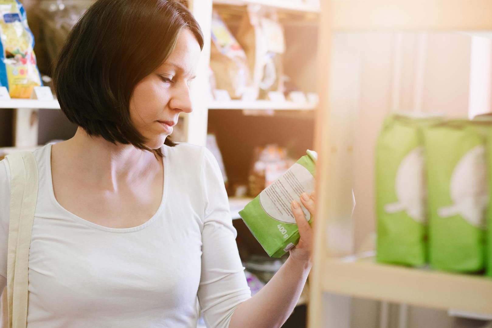 Eine Frau schaut sich die Inhaltsstoffe von Lebensmitteln an