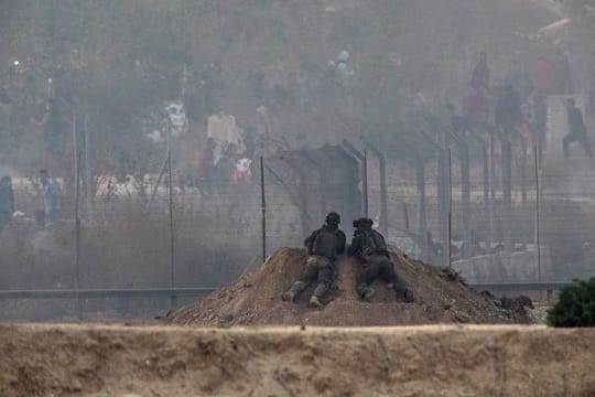 Israelische Soldaten beobachten bei Zusammenstößen zwischen palästinensischen Demonstranten und israelischen Soldaten im Gazastreifen die palästinensische Seite.
