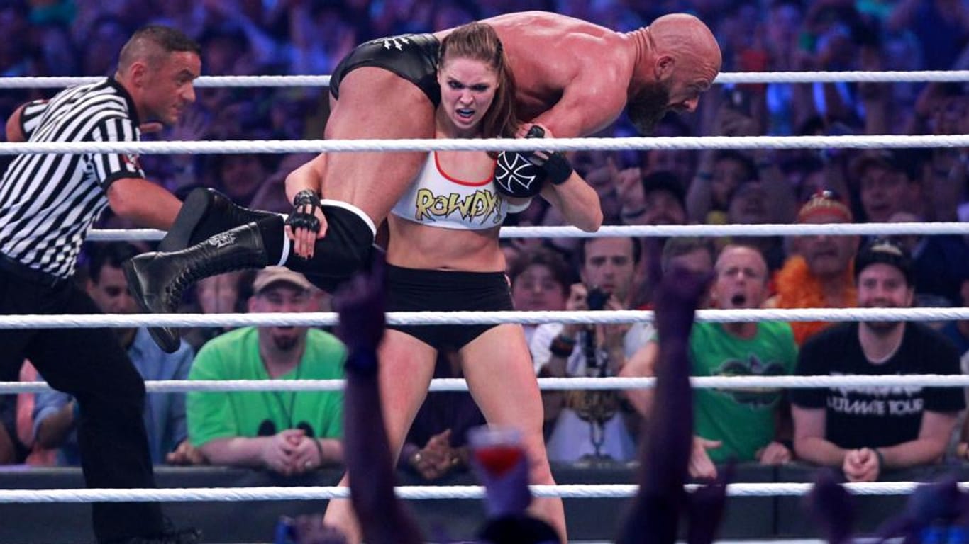 Über 100 Kilo auf den Schultern: Ronda Rousey trägt Triple H durch den Ring.