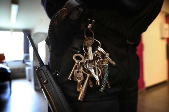 Ein Wachmann steht im Gefängnis Norgerhaven in den Niederlanden vor einer Zelle.