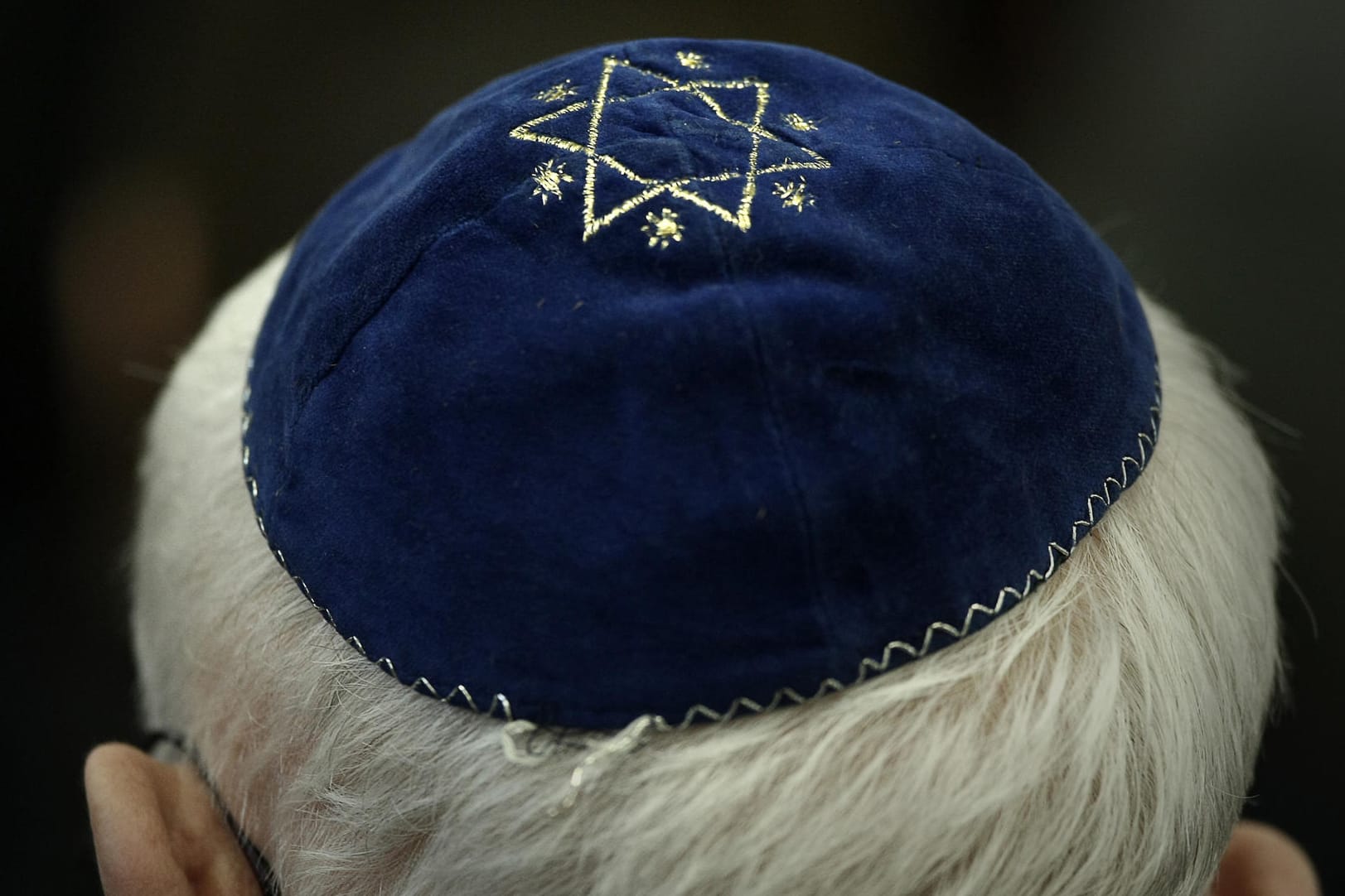 Ein Mann trägt eine Kippa mit einem aufgenähtem Stern: Zentralratspräsident rät Einzelpersonen vom Tragen der Kippa in Großstädten ab.