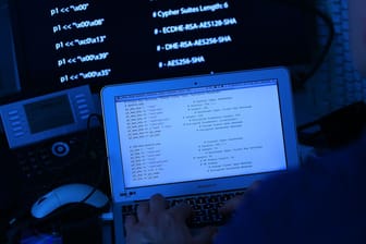 Ein Mann ruft den Quellcode einer Software auf: Der Verfassungsschutz will Hacker künftig präventiv angreifen.