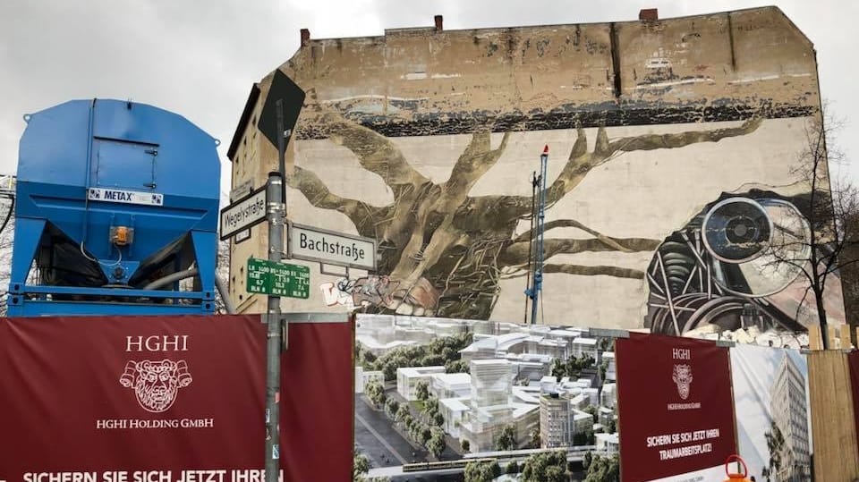 Berlin, Bezirk Tiergarten: Der alte Weltbaum verschwindet hinter der Fassade eines Neubaus.