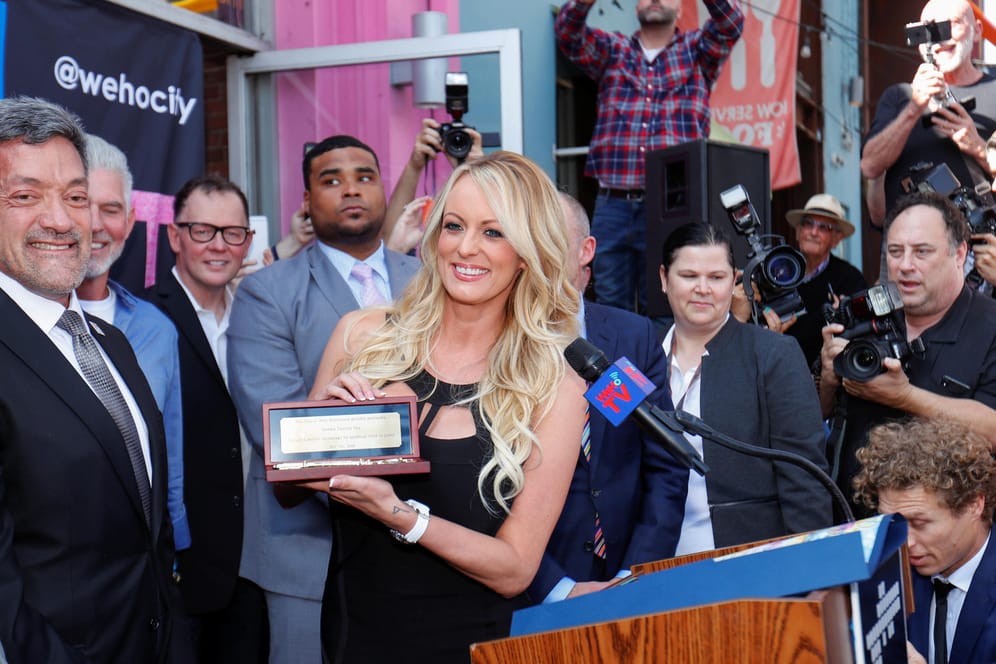 Stormy Daniels stands next to West Hollywood Mayor John J. Duran after being presented with a key to the city during a ceremony in West Hollywood
